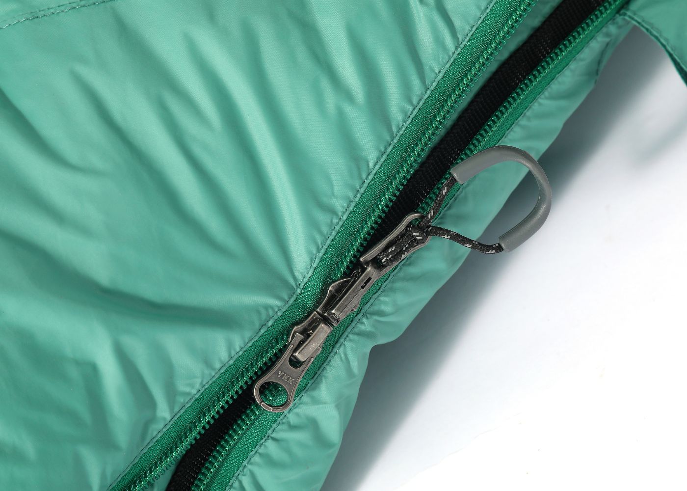 Close-up view of reinforced stitching and double zipper for durability in ultralight sleeping bag