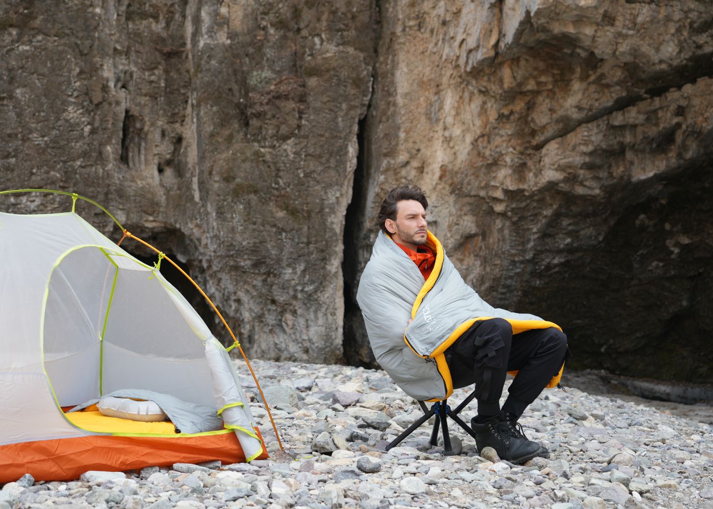 Down sleeping bag featuring insulated hood and shoulder baffle for enhanced warmth