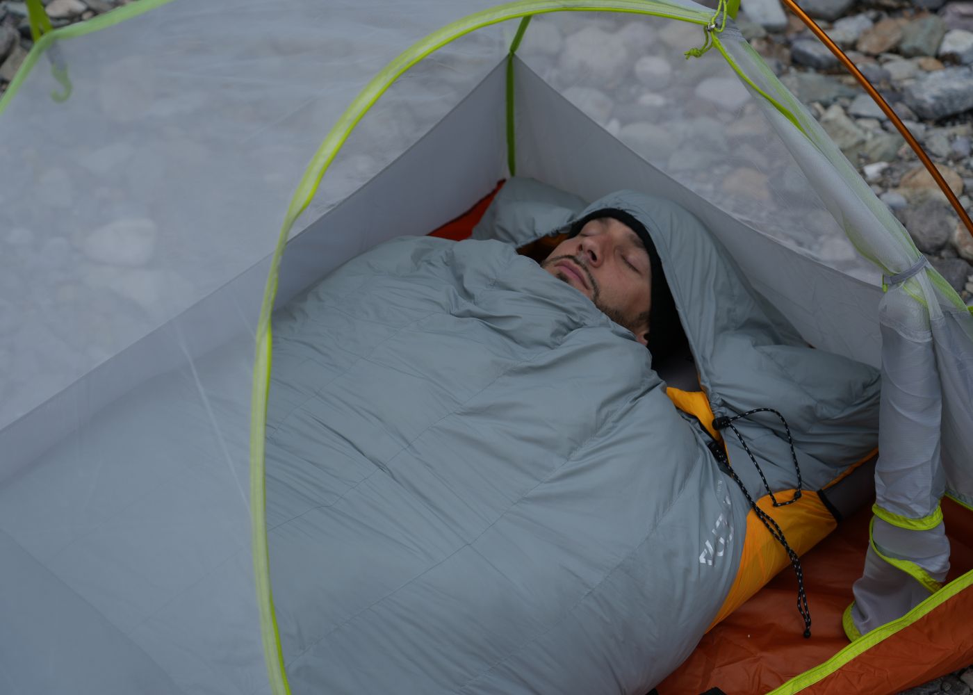 Down sleeping bag keeping campers warm and comfortable through cold nights outdoors
