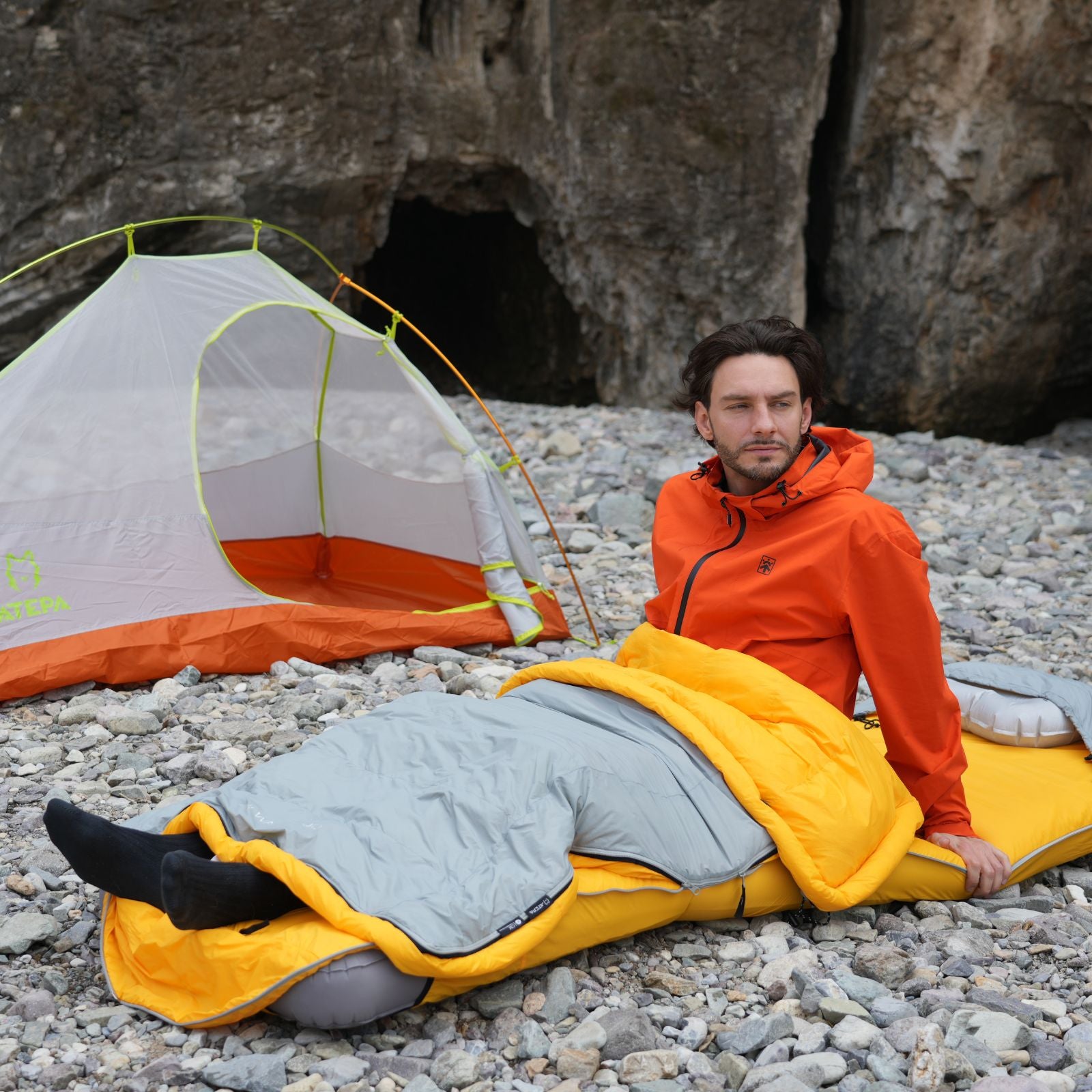 Down sleeping bag placed inside a tent for overnight outdoor camping