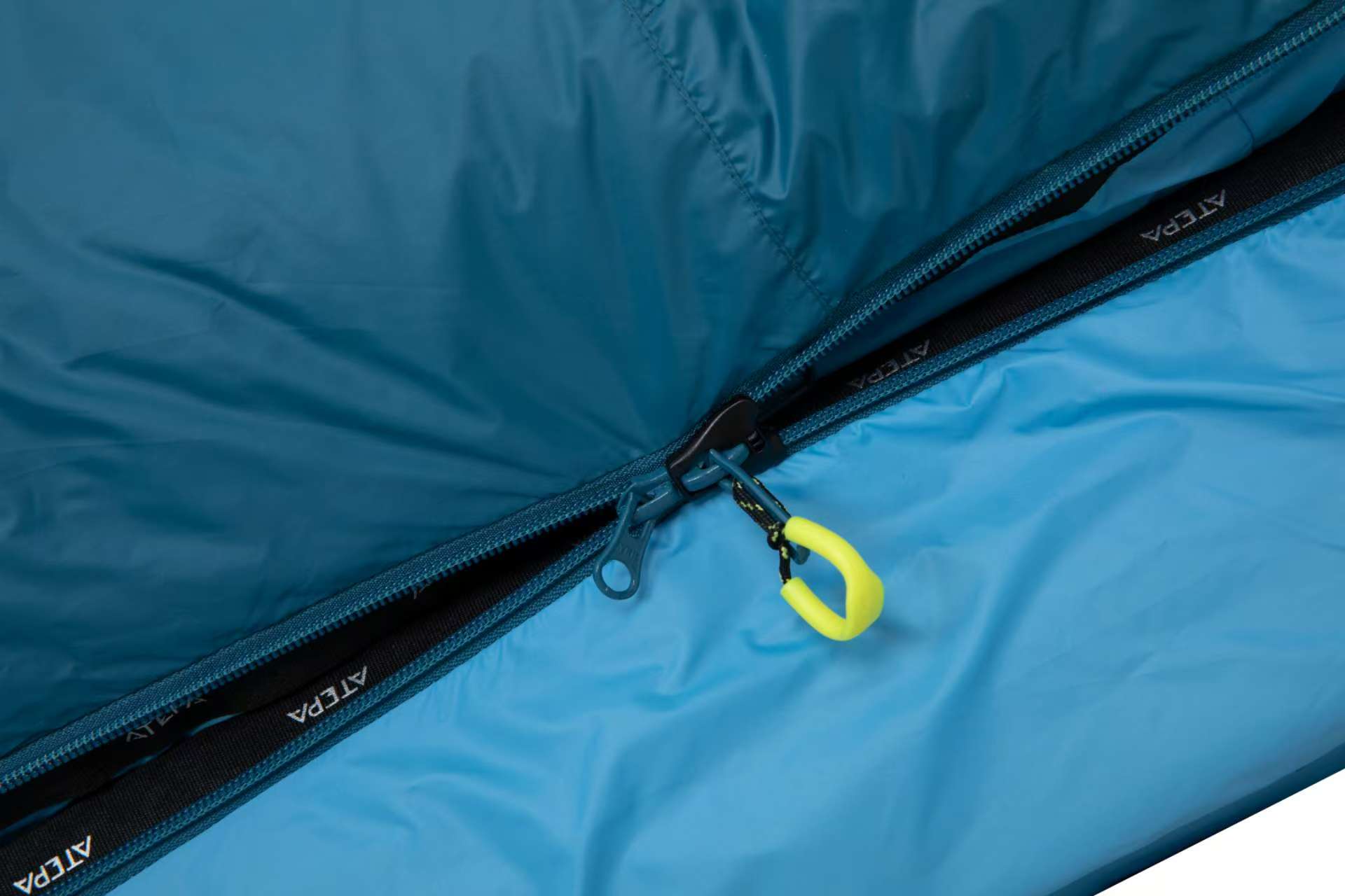 Zipper and snap system of blue sleeping bag for flexible adjustment and ventilation