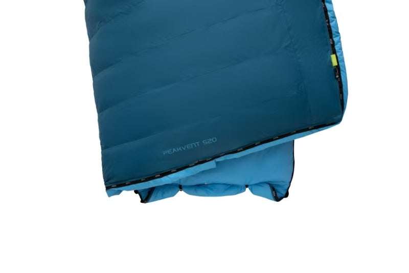 Blue lightweight sleeping bag with storage bag and repair kit accessories