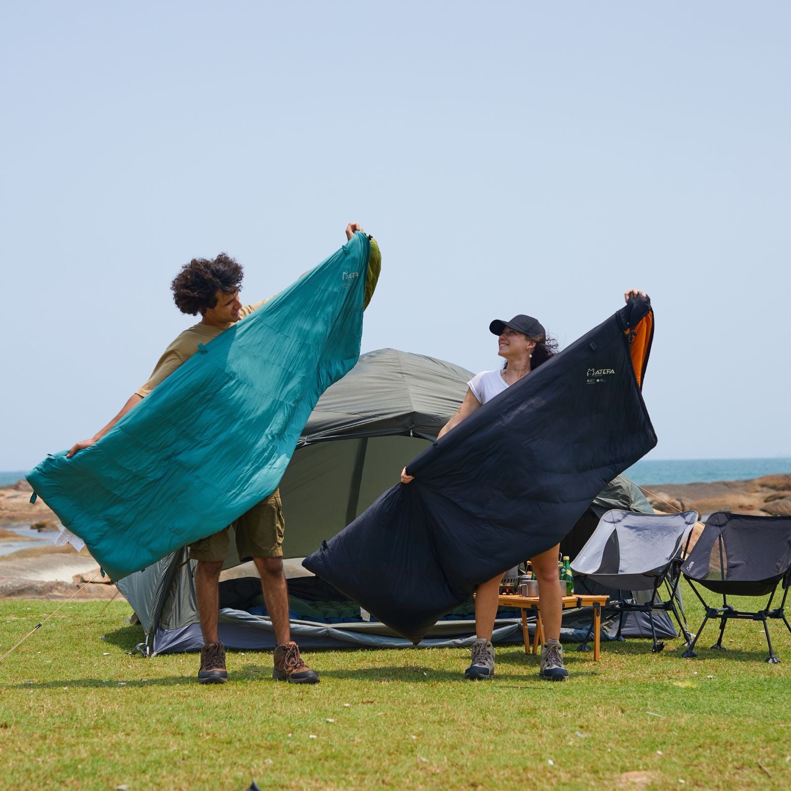 Down sleeping bag set up inside tent for warm overnight camping experience