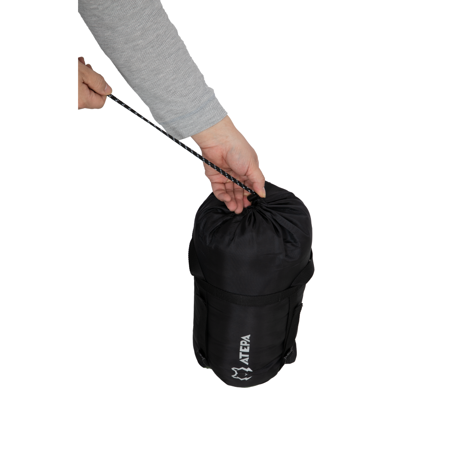 Sleeping bag packed compactly into compression sack for backpacking